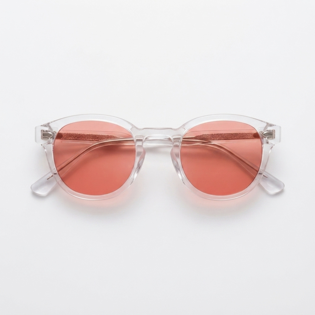 Round sunglasses with translucent clear frames and rose pink lenses, shown from a top-down view on a light gray background.