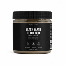 A jar of Better Human Earth Lab Black Earth Detox Mud on a clean white background. The product features a black ribbed screw cap, a black label with white text, and a light brown detox mud visible through the clear jar.