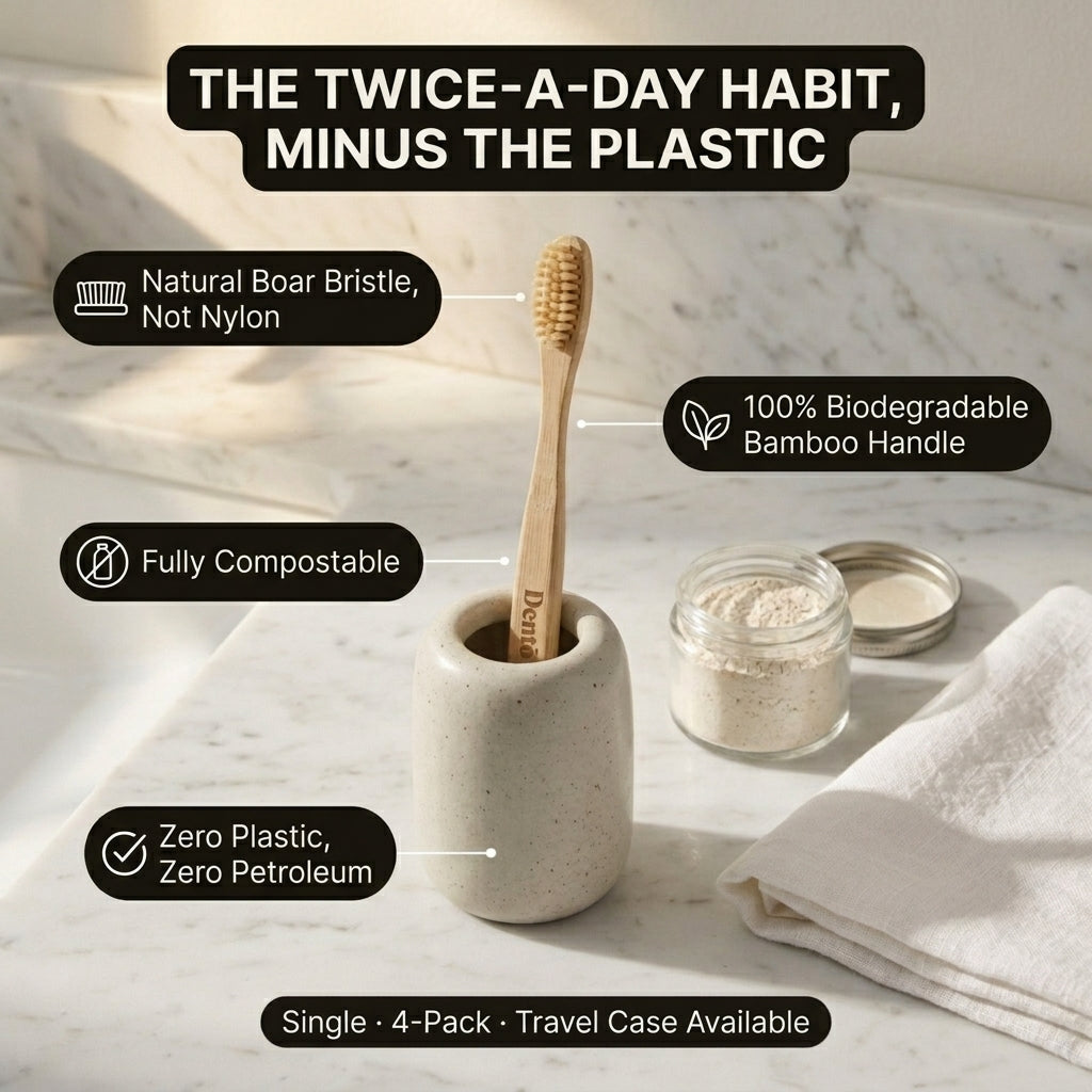 A bamboo toothbrush with a natural wood handle stands in a speckled ceramic holder on a marble surface. Text callouts describe eco-friendly features: natural boar bristle, 100% biodegradable bamboo handle, fully compostable, and zero plastic.