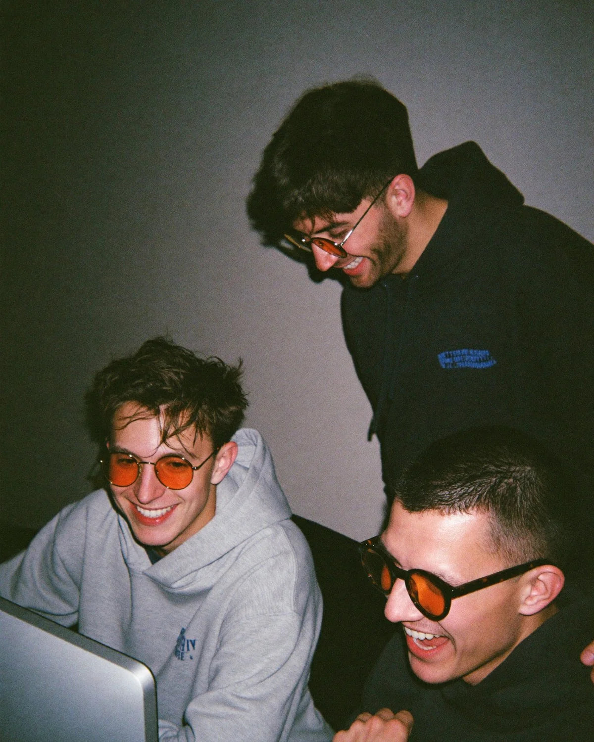Three friends on a computer late at night wearing LITEZ Focus lenses