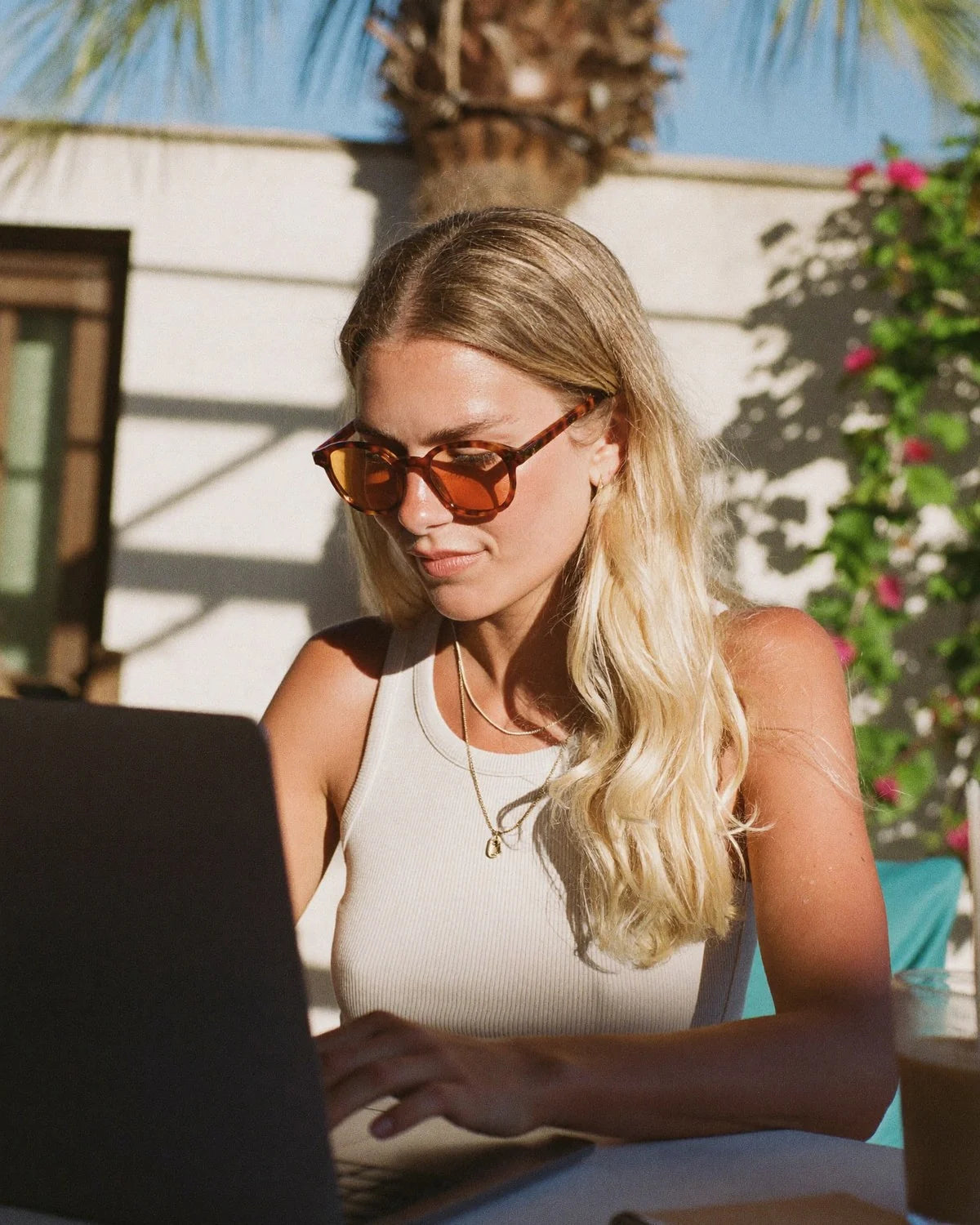 Woman working on a laptop outdoors in LA wearing LITEZ lenses