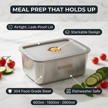 A stainless steel meal prep container with a leak-proof lid and food storage compartment, shown on a light marble surface with tomatoes, cucumber slices, and overlaid feature callouts including 'Meal Prep That Holds Up,' 'Airtight, Leak-Proof Lid,' 'Stackable Design,' '304 Food-Grade Steel,' and 'Dishwasher Safe.'.
