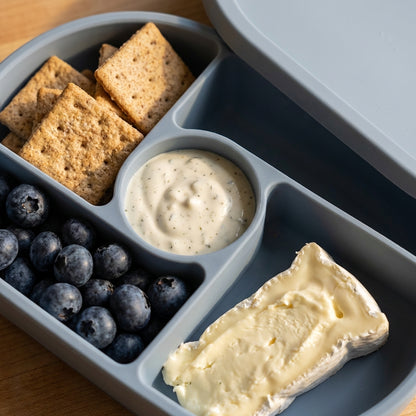 Silicone Bento Box — Ocean Blue, lifestyle photo shown open with food inside.