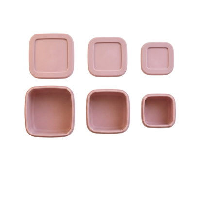Silicone Food Storage Container, Bite configuration, Blush Pink, product photo on a white background.