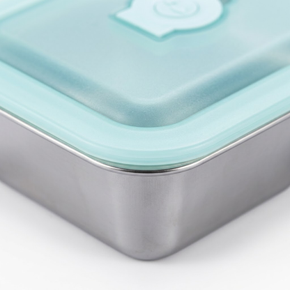Close-up of a rectangular metal lunch box with a translucent mint green lid and matching rim, shown on a clean white background.